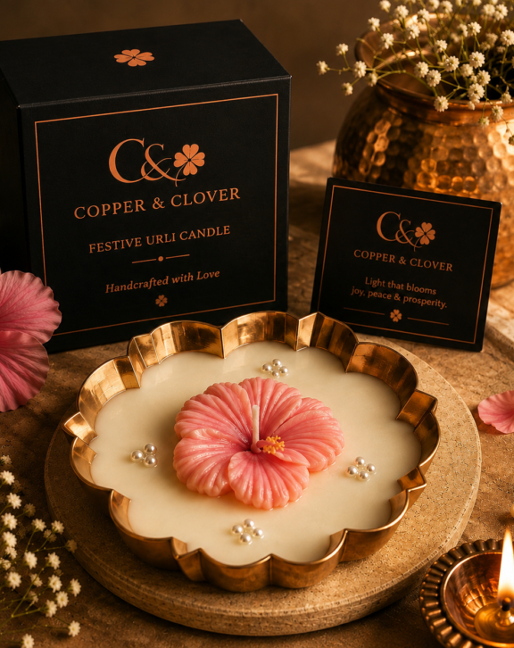 An expression of light, artistry & celebration. Handcrafted in an elegant golden urli, this exquisite candle brings together luminous ivory wax and a richly sculpted floral arrangement in vibrant festive hues. Every detail is thoughtfully crafted to create a statement of Indian artistry, warmth and refined celebration. Made to grace festive spaces, joyful gatherings, new beginnings and cherished occasions. Copper & Clover Handcrafted with Love