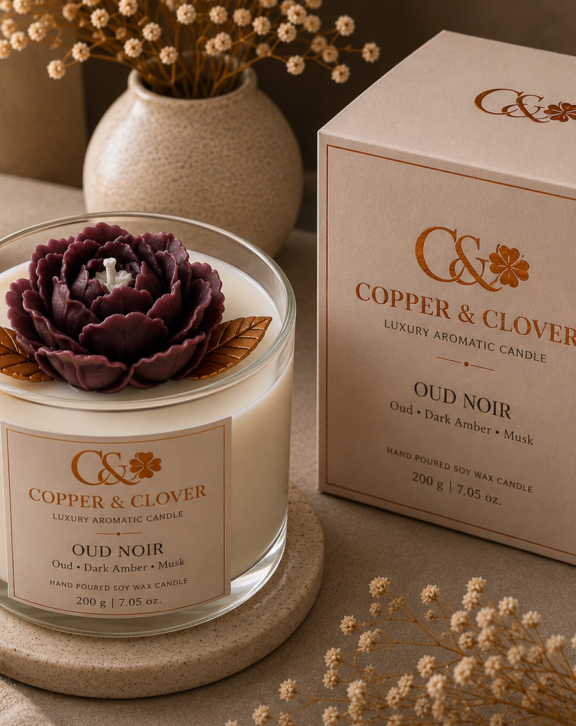 An expression of depth, warmth & refined indulgence. Handcrafted with a dramatic sculpted floral bloom in rich plum tones, this luxurious candle embodies the mysterious character of Oud Noir. Set against luminous ivory wax with elegant golden detailing, it brings together artisanal craftsmanship and a sophisticated, opulent aesthetic. Perfect for luxurious interiors, evening ambience, distinguished gifting and special occasions. Copper & Clover Handcrafted with Love